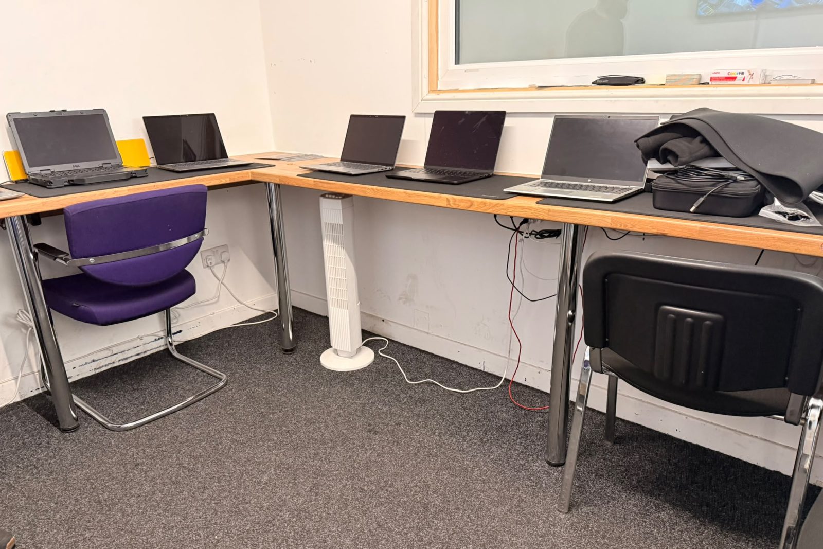 Laptops lined up for testing on the bench at our processing facility