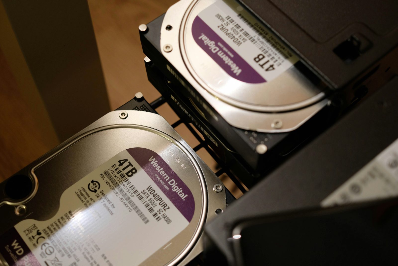 Retired hard drives stacked ready for processing